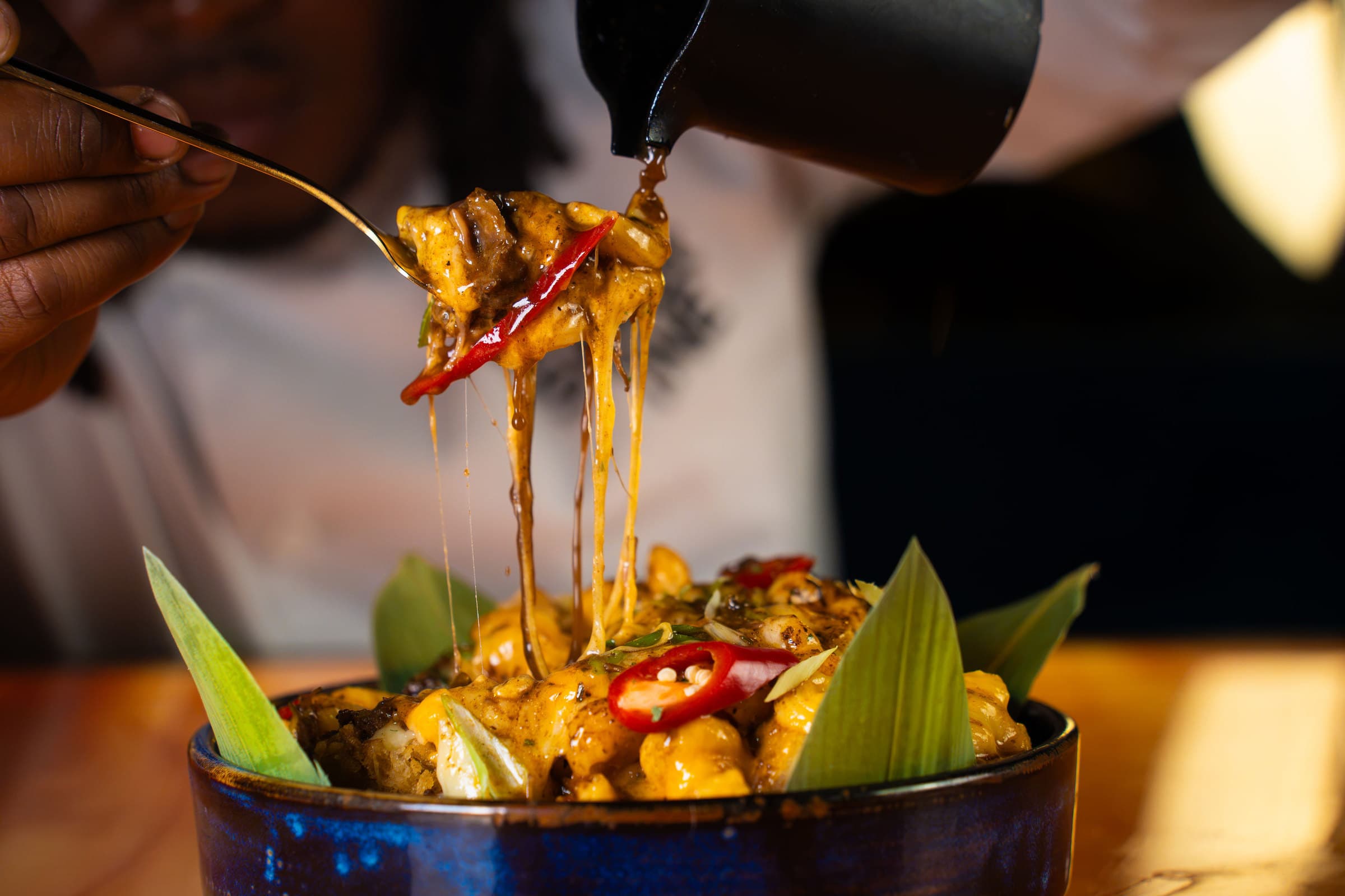Gravy poured over cheesy oxtail mac